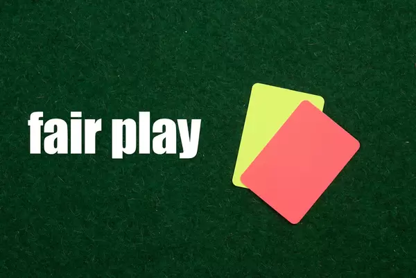 Referee cards with Fair play text on green grass
