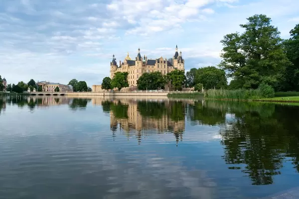 Reflection of a beautiful Schwerin castle in nearby lake during the blue hour