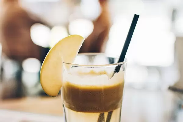 Refreshing apple drink. Blurry background