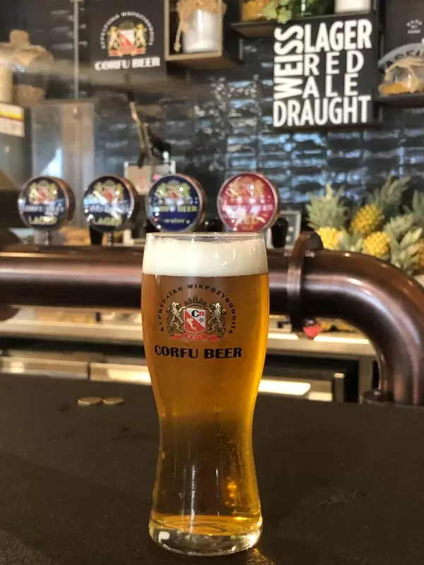 Refrigerated Corfu beer on a black counter of a Greek bar, at Eleftherios Venizelos airport near Athens