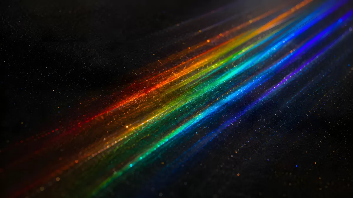 Regenbogenspektrum aus Lichtpartikeln auf dunklem Hintergrund