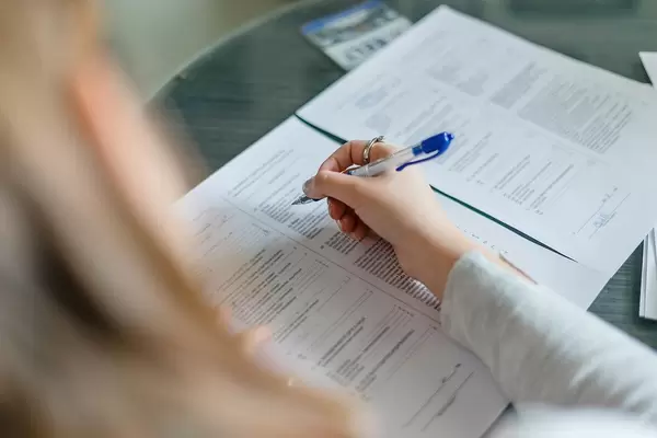 Registration with official documents: Woman filling out some forms