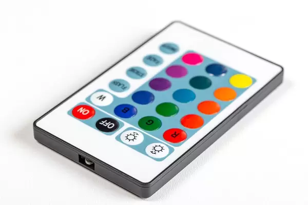 Remote control with multi-colored buttons on a white background