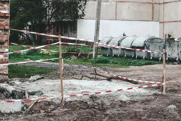 Repair work fenced by red and white striped barrier tape