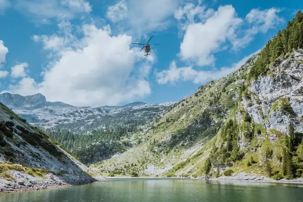Rescue helicopter flying above Krn lake