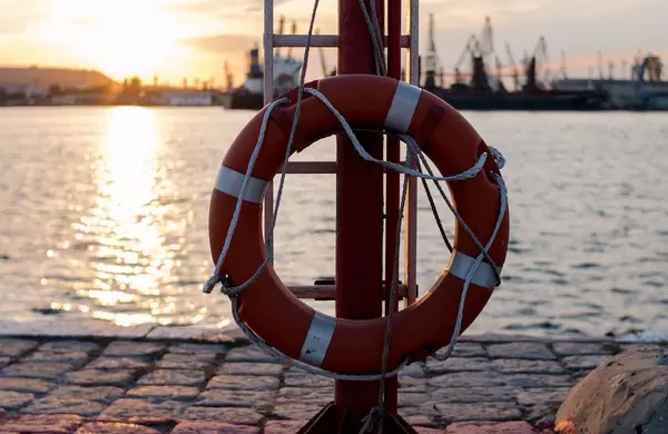 Rescue: Lifebelt at sea port. Sunset view