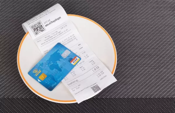 Restaurant bill and credit card on table