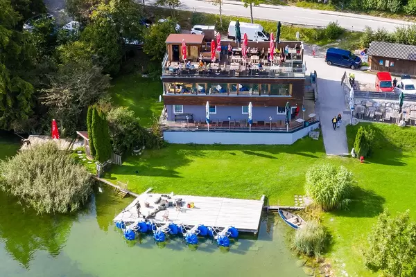 Restaurant-Café Fischerstube at Lake Reintal in Austria. Aerial view with wooden platform for anglers