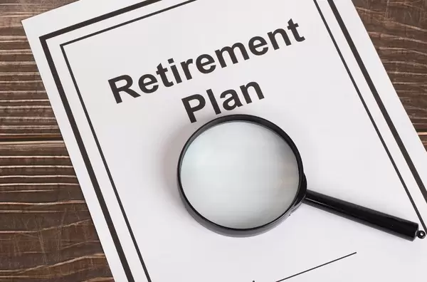Retirement Plan with magnifying glass
