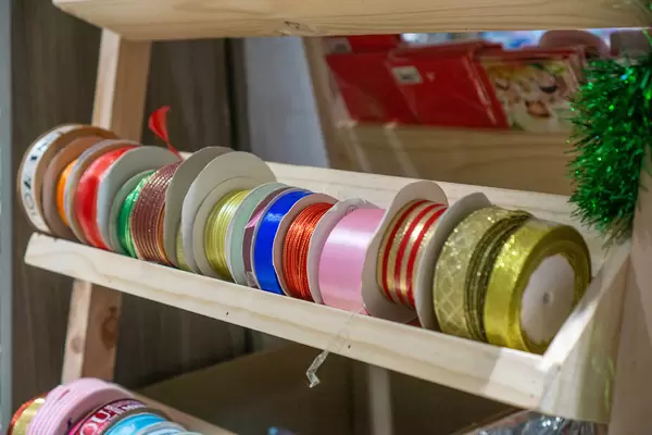 Ribbons in different Colors and Sizes for Gift Wrapping in a Craft Supply Section in a Bookstore