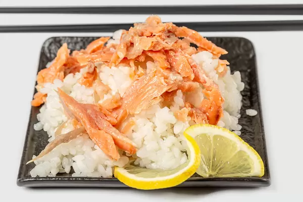 Rice with fish slices and lemon, close-up