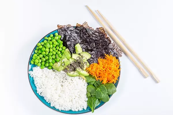 Rice with fresh vegetables, spinach and nori. The view from the top