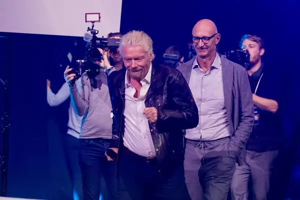 Richard Branson runs on stage at DigitalX in Cologne