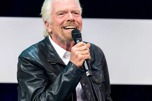 Richard Branson smiles to the audience and talks at Digital X in Cologne
