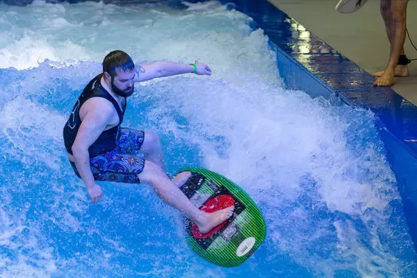 Riding the wave on the Citywave surf machine at fair Boot Düsseldorf 2018