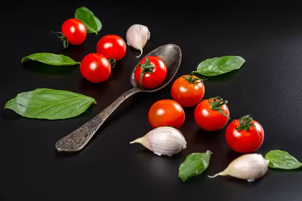 Ripe cherry tomatoes with garlic and basil