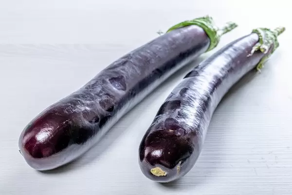 Ripe eggplant on white wooden background (Flip 2019)