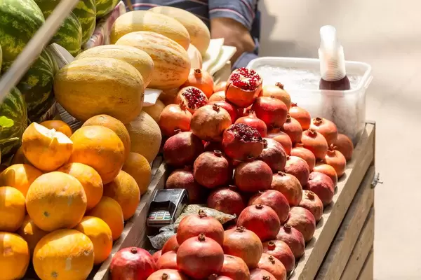 Ripe melons and pomegranates at Danilovsky Market in Moscow