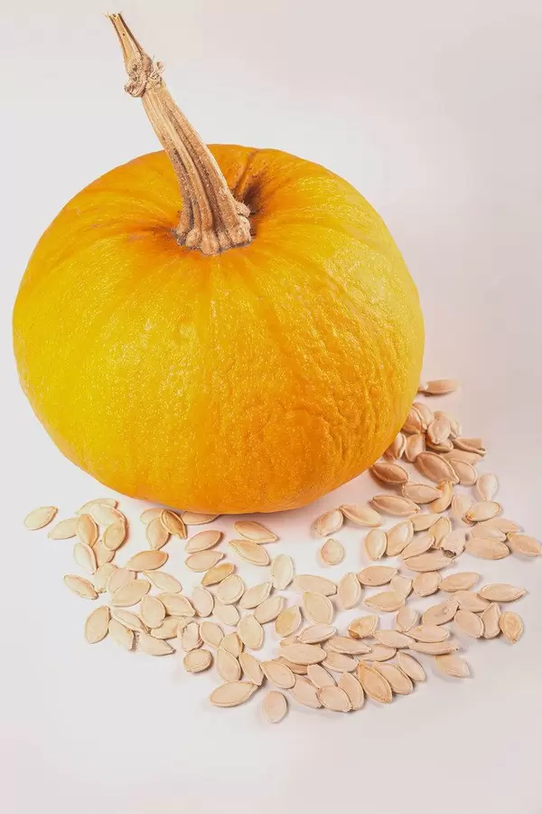 Ripe orange pumpkin with pumpkin seeds