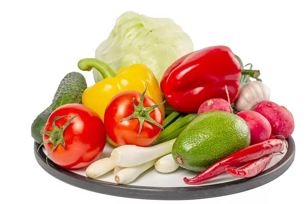 Ripe vegetables on a round kitchen board