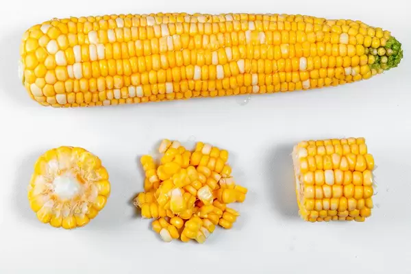Ripe yellow corn on white background