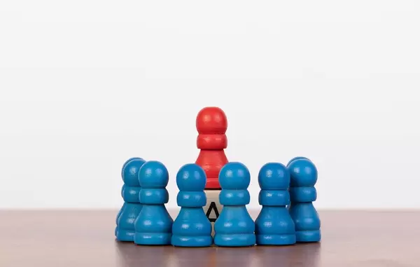 Rising above the rest concept with toy pawn figures