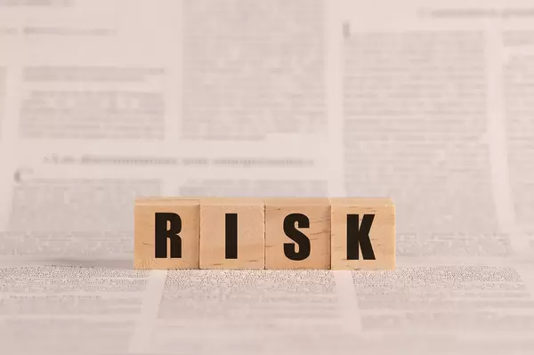 Risk written with cubes on a newspaper