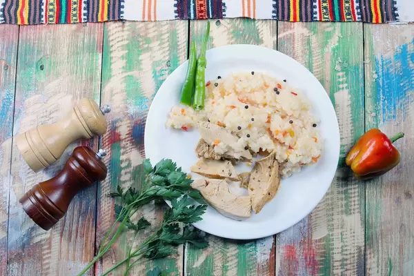Roast chicken and rice with parsley and bell pepper, salt cellar