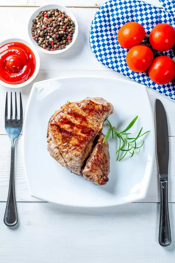 Roasted fresh steak with fork and knife