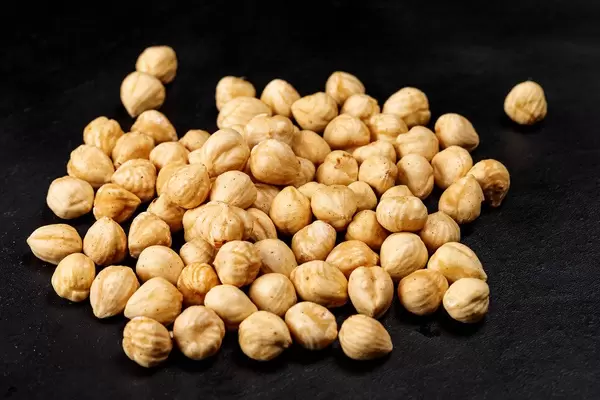 Roasted hazelnuts on a black background (Flip 2020)