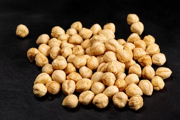 Roasted hazelnuts on a black background