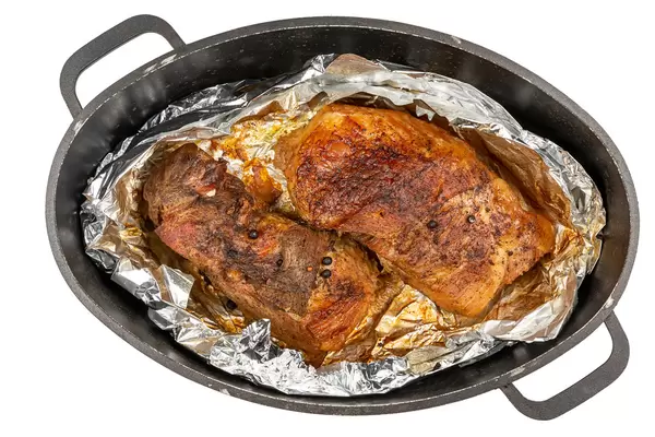 Roasted pork fillet with spices in a brazier, top view