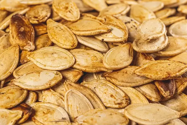Roasted pumpkin seeds background, close-up