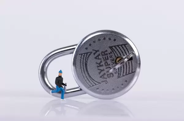 Robber and padlock on white background