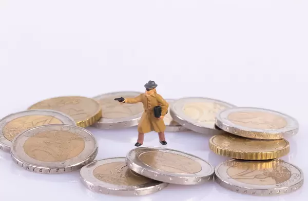 Robber with gun surrounded with coins