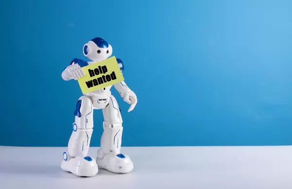 Robot holding a sing with Help wanted text