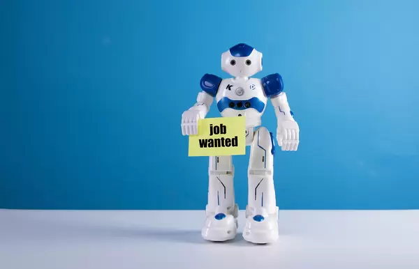 Robot holding a sing with Job wanted text