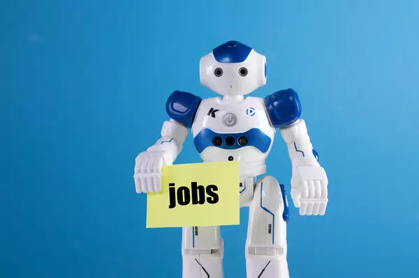 Robot holding a sing with Jobs text