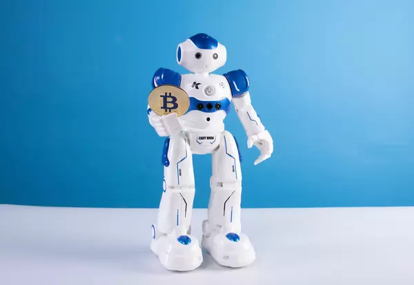 Robot holding golden Bitcoin coin