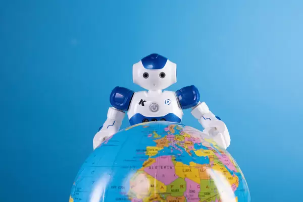 Robot with globe on blue background