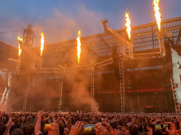 Rock fans in front of the stage set with flamethrower for the WorldWired tour - Metallic concert in Cologne, Germany