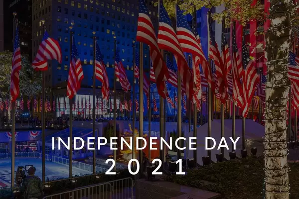 Rockefeller Center during Election Night with a sea of American flags on flagpoles, with the title text Independence Day 2021