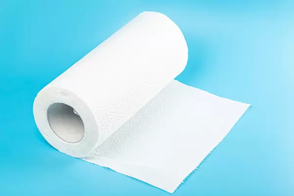 Roll of paper kitchen towels on blue