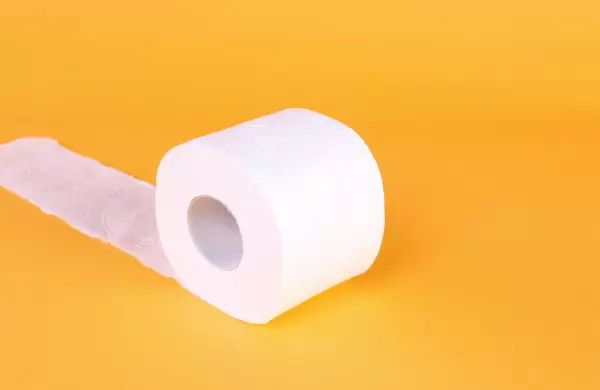 Roll of toilet paper on a orange background