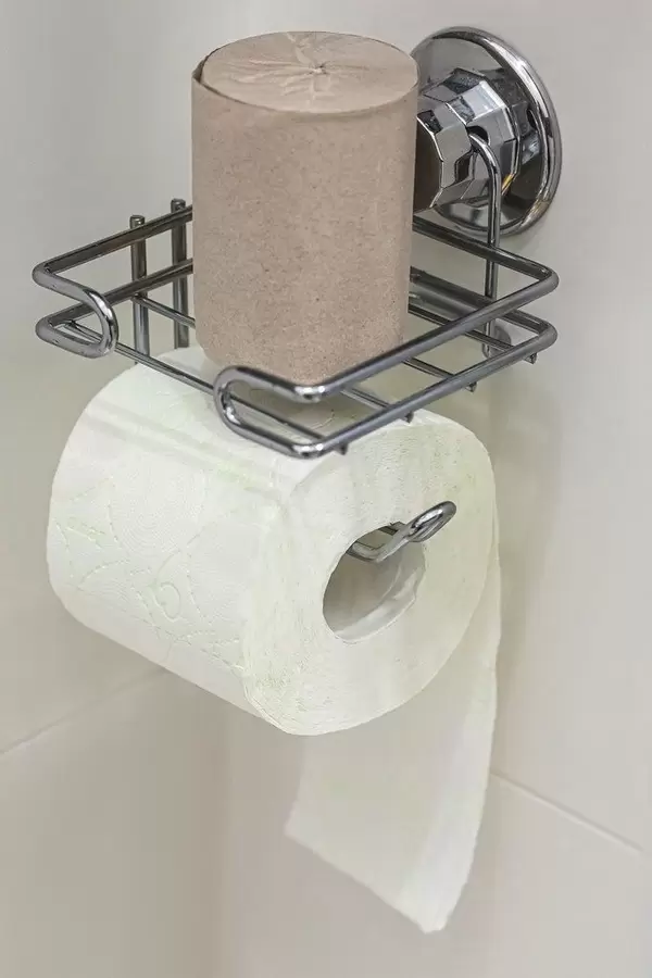 Roll of white toilet paper on metal paper holder