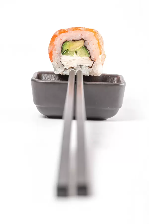 Roll philadelphia with soy sauce and chopsticks