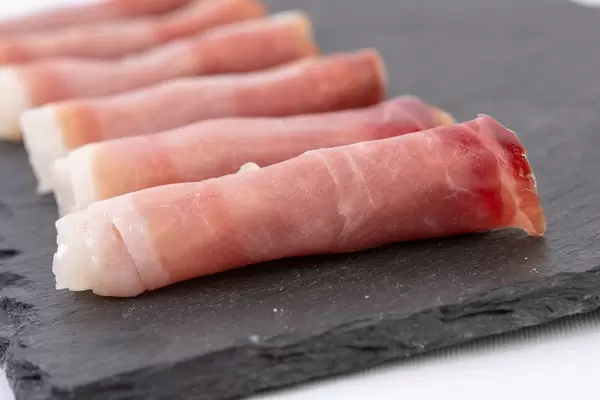 Rolled Pork Ham meat on the black stone tray (Flip 2019)