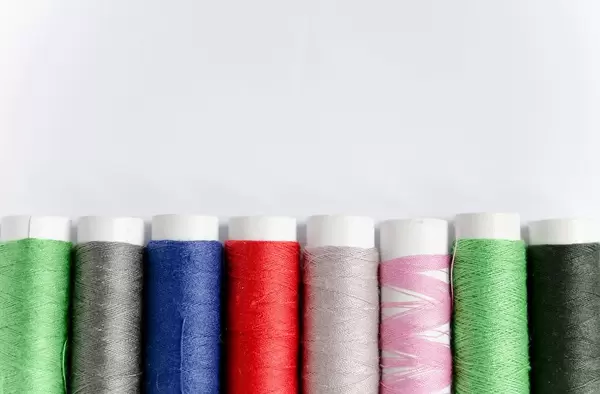 Rolled yarn of different colours on a white background