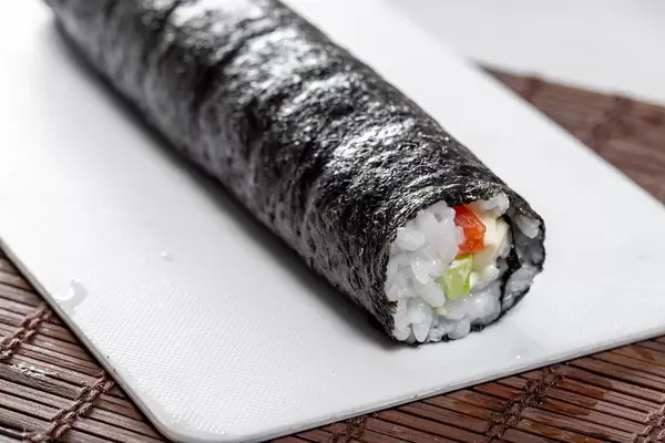 Rolling sushi maki. Preparation of Maki rolls with salmon