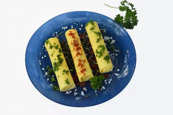 Rolls of cheese with herbs and peppers